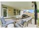 Cozy covered patio with comfortable seating, outdoor dining, and a charming view of the backyard at 158 Bluffton Rd, Mooresville, NC 28115