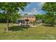 Expansive backyard showcasing a beautiful brick home, large pool, and lush greenery at 1614 Crestgate Dr, Waxhaw, NC 28173