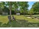 Serene backyard with manicured lawn, shed, trampoline and mature trees provides a peaceful outdoor retreat at 1614 Crestgate Dr, Waxhaw, NC 28173