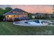Stunning backyard with a large in-ground pool, poolside lounge area, and a covered deck for relaxation at 1614 Crestgate Dr, Waxhaw, NC 28173