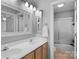 Bright bathroom featuring double vanity, framed mirror, and walk-in shower with glass doors at 1614 Crestgate Dr, Waxhaw, NC 28173