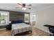 Stylish bedroom with a wood accent wall, hardwood floors, and views of the backyard at 1614 Crestgate Dr, Waxhaw, NC 28173
