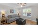 This bedroom features a sofa, a hardwood floor, a ceiling fan, and a large window at 1614 Crestgate Dr, Waxhaw, NC 28173