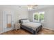 Comfortable bedroom showcasing hardwood floors, natural light, and a cozy bed with decorative pillows at 1614 Crestgate Dr, Waxhaw, NC 28173