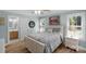 Light bedroom with a hardwood floor, shutters, and a view to an ensuite bath at 1614 Crestgate Dr, Waxhaw, NC 28173