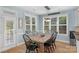 Inviting dining room with a rustic wooden table and ample natural light at 1614 Crestgate Dr, Waxhaw, NC 28173