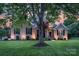 Charming brick home featuring a well-manicured lawn, a red door, and traditional black shutters at 1614 Crestgate Dr, Waxhaw, NC 28173