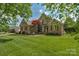 Beautiful brick home with black shutters, landscaping, and a lush lawn, providing curb appeal at 1614 Crestgate Dr, Waxhaw, NC 28173
