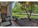 Charming front porch view with inviting chairs and lush landscaping at 1614 Crestgate Dr, Waxhaw, NC 28173