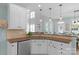 Bright kitchen features updated countertops, stainless steel appliances, and modern pendant lighting at 1614 Crestgate Dr, Waxhaw, NC 28173