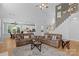 Open-concept living room with a staircase, a ceiling fan, hardwood floors, and two sofas at 1614 Crestgate Dr, Waxhaw, NC 28173