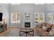Bright living room featuring a fireplace, large windows, and hardwood floors at 1614 Crestgate Dr, Waxhaw, NC 28173