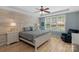 Stylish main bedroom with a ceiling fan, hardwood floors, natural light, and a chair at 1614 Crestgate Dr, Waxhaw, NC 28173
