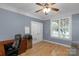Comfortable office space with hardwood floors, a ceiling fan, and a wooden executive desk at 1614 Crestgate Dr, Waxhaw, NC 28173