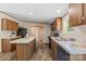 Bright kitchen showcases center island, wood cabinets, granite countertops, and plank flooring at 1649 Cloudburst Cir # 6, Lincolnton, NC 28092