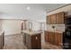 Open kitchen featuring center island, wood cabinets and plank flooring throughout at 1649 Cloudburst Cir # 6, Lincolnton, NC 28092