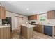 Well-lit kitchen features wood cabinets, a center island, and dark appliances at 1649 Cloudburst Cir # 6, Lincolnton, NC 28092