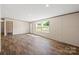 Bright living room featuring wood-look flooring, neutral walls, and ample natural light at 1649 Cloudburst Cir # 6, Lincolnton, NC 28092