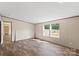 Open living room featuring plank floors, neutral walls, and bright natural light at 1649 Cloudburst Cir # 6, Lincolnton, NC 28092
