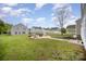 Large backyard features a well-manicured lawn, fire pit area, and is perfect for outdoor entertainment at 1911 Almond Hills Dr, Charlotte, NC 28262