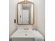Cozy bathroom featuring a white vanity, chrome faucet, and a decorative gold mirror at 1911 Almond Hills Dr, Charlotte, NC 28262