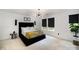 Bedroom featuring a stylish black bed frame, modern lighting, and neutral carpet at 1911 Almond Hills Dr, Charlotte, NC 28262