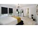 Bright bedroom with windows, carpet, modern light fixture, and a large, decorative mirror at 1911 Almond Hills Dr, Charlotte, NC 28262