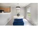 Bright dining room featuring a modern chandelier and round table with blue chairs at 1911 Almond Hills Dr, Charlotte, NC 28262