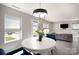 An open-concept dining room with a view of the living room and backyard at 1911 Almond Hills Dr, Charlotte, NC 28262