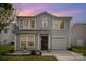 Charming two-story home featuring gray siding, an attached garage, and a well-manicured front lawn, perfect for curb appeal at 1911 Almond Hills Dr, Charlotte, NC 28262