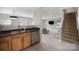 Updated kitchen leads to living room with stainless steel dishwasher and sink at 1911 Almond Hills Dr, Charlotte, NC 28262