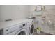 Functional laundry room equipped with washer, dryer, and wire shelving for storage at 1911 Almond Hills Dr, Charlotte, NC 28262
