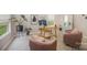 Bright living room featuring stylish decor, including comfortable chairs, a sleek desk, and lots of natural light at 1911 Almond Hills Dr, Charlotte, NC 28262
