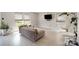 Bright living room featuring large windows, grey sofa, and indoor swing at 1911 Almond Hills Dr, Charlotte, NC 28262