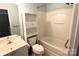 Bathroom featuring a shower-tub combo, tiled flooring, and a white vanity with storage shelving at 2043 Shady Pond Dr, Clover, SC 29710