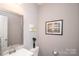 Clean, modern bathroom with vanity, framed mirror, and neutral color palette at 2207 Atwell Glen Ln, Pineville, NC 28134
