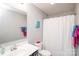 Bathroom features a white shower curtain, light countertops, and colorful towels at 2207 Atwell Glen Ln, Pineville, NC 28134