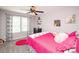 Charming bedroom with bright pink accents, a ceiling fan, and decorative art at 2207 Atwell Glen Ln, Pineville, NC 28134