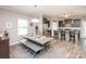 Open dining area with modern table setup flowing seamlessly into the kitchen at 2207 Atwell Glen Ln, Pineville, NC 28134