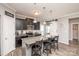 Stylish kitchen island with granite countertop and bar stool seating at 2207 Atwell Glen Ln, Pineville, NC 28134