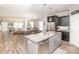 Open-concept kitchen with granite island, stainless appliances, and an adjacent dining and living area with ample natural light at 2207 Atwell Glen Ln, Pineville, NC 28134