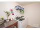 Bright laundry room featuring a modern washer and dryer, countertop and storage at 2207 Atwell Glen Ln, Pineville, NC 28134