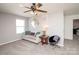 Comfortable living room features a couch, accent chair, and modern ceiling fan at 2207 Atwell Glen Ln, Pineville, NC 28134