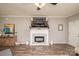 Bright living room featuring a modern fireplace, mounted tv, and white decorative elements at 2207 Atwell Glen Ln, Pineville, NC 28134