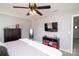 Well-lit main bedroom features contemporary decor, including a wall-mounted television and ceiling fan at 2207 Atwell Glen Ln, Pineville, NC 28134