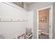 Mudroom featuring bench with colorful cushion, coat hooks, and access to a half bathroom at 2207 Atwell Glen Ln, Pineville, NC 28134
