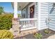 Charming front porch with a decorated door, offering a warm and inviting entrance to the home at 2207 Atwell Glen Ln, Pineville, NC 28134