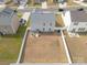 Aerial view of a gray home with large backyard, patio, and white fence at 228 Brownstone Dr, Rock Hill, SC 29730