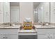 Dual sink bathroom vanity with granite countertops and a decorative bamboo shelving unit at 228 Brownstone Dr, Rock Hill, SC 29730
