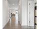 Bright hallway with hardwood floors leading to a well-lit living area and backyard access at 228 Brownstone Dr, Rock Hill, SC 29730